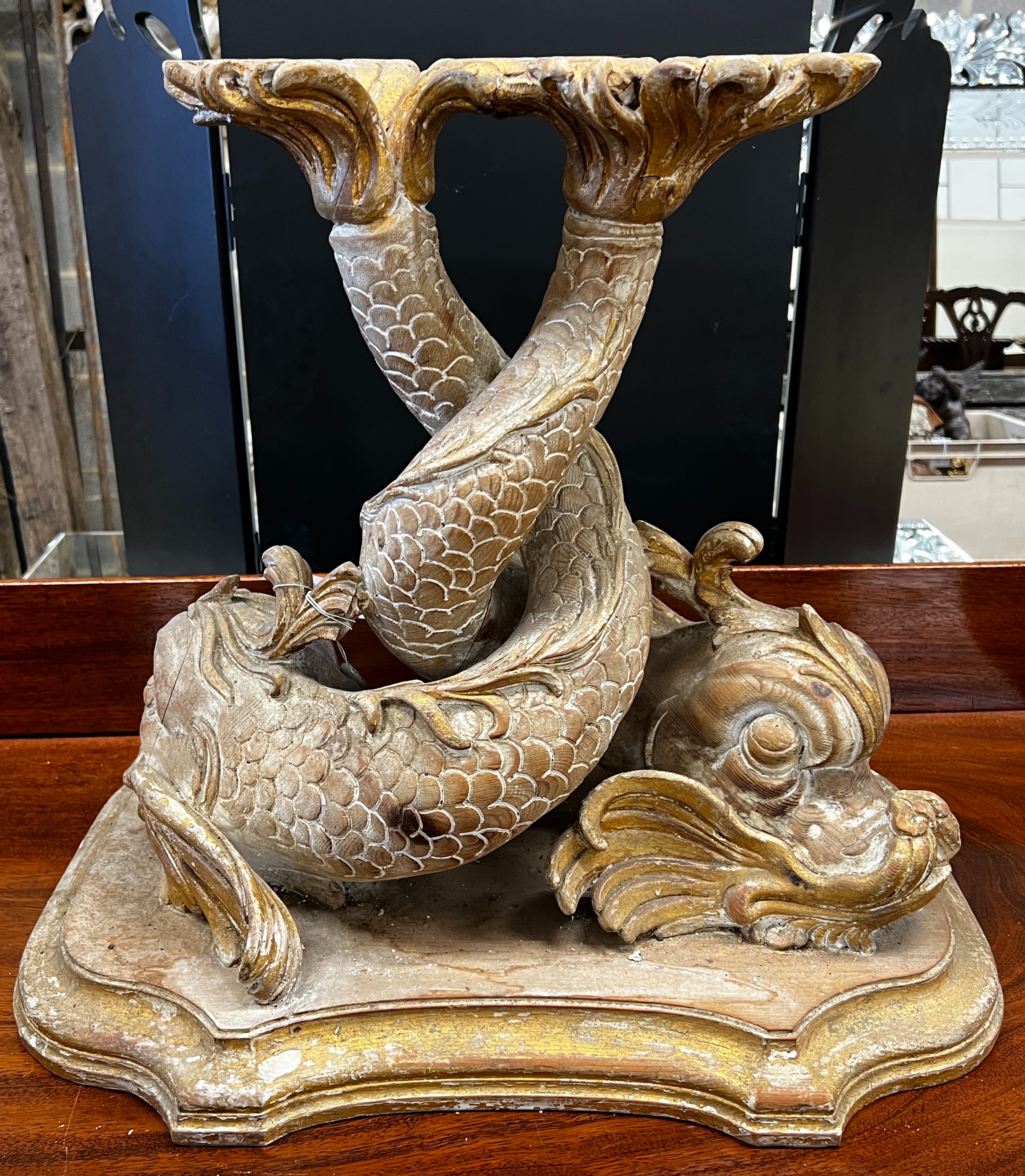 A 19th century carved parcel gilt pine entwined dolphin support, width 54cm, height 50cm